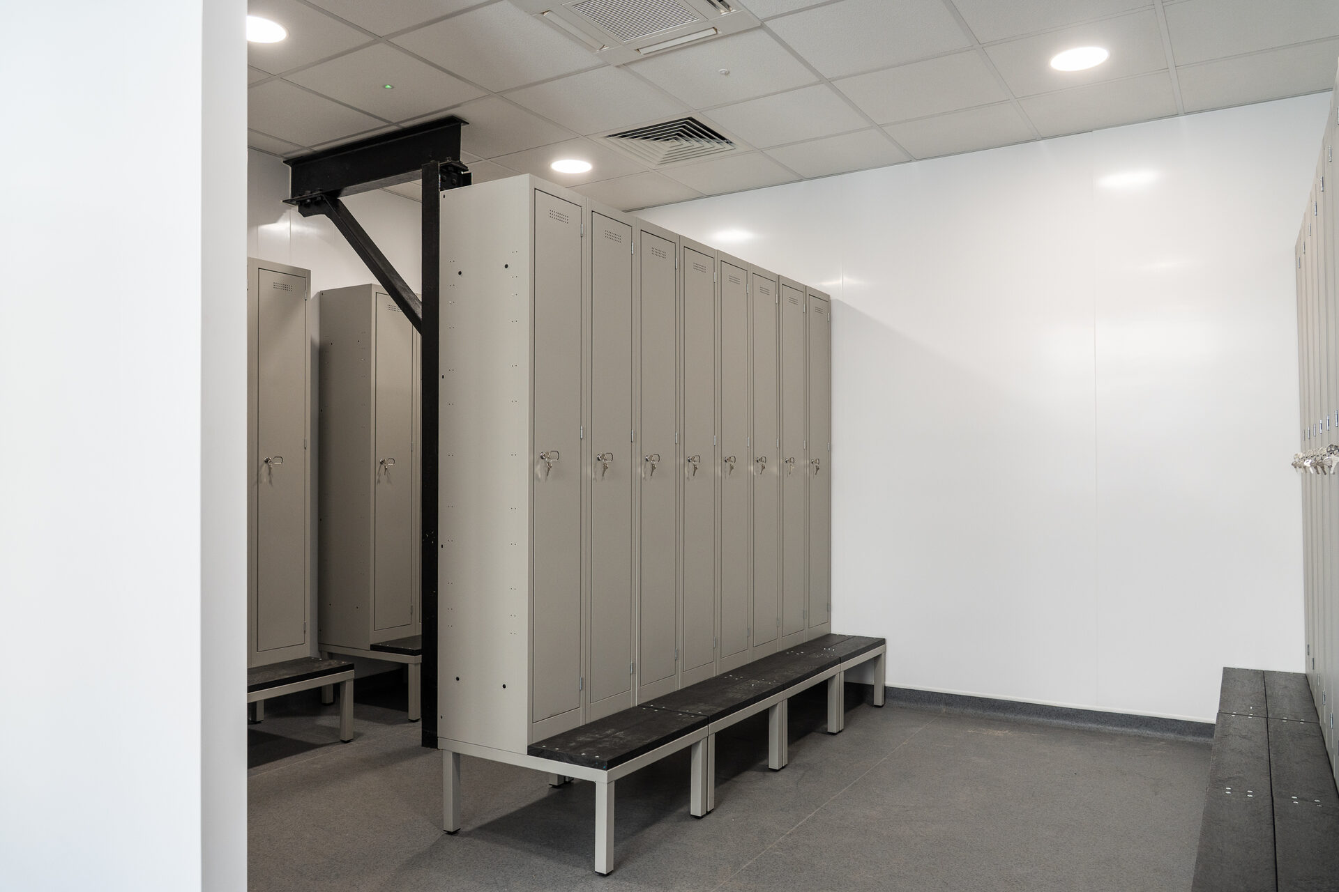 Changing room at Breedon, with a run of lockers and slatted bench seating