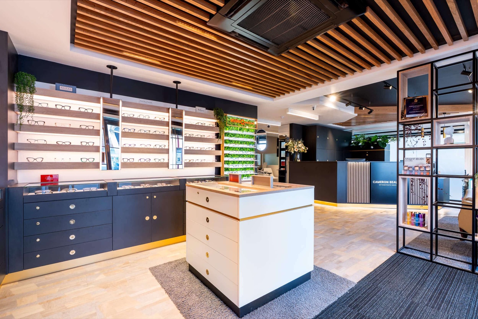 Cameron Beaumont opticians shopfront with glasses display shelving and a central island counter
