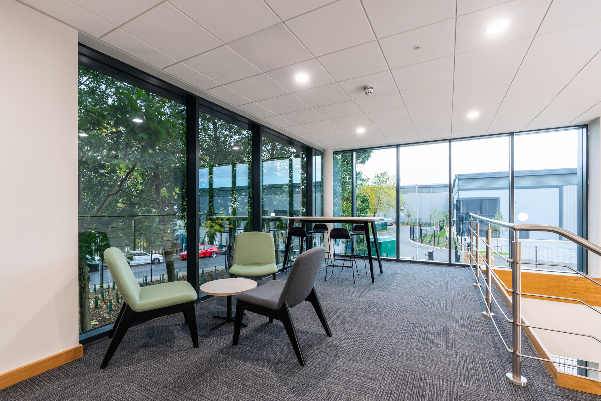 Glass balustrade edging the mezzanine breakout level at Garolla