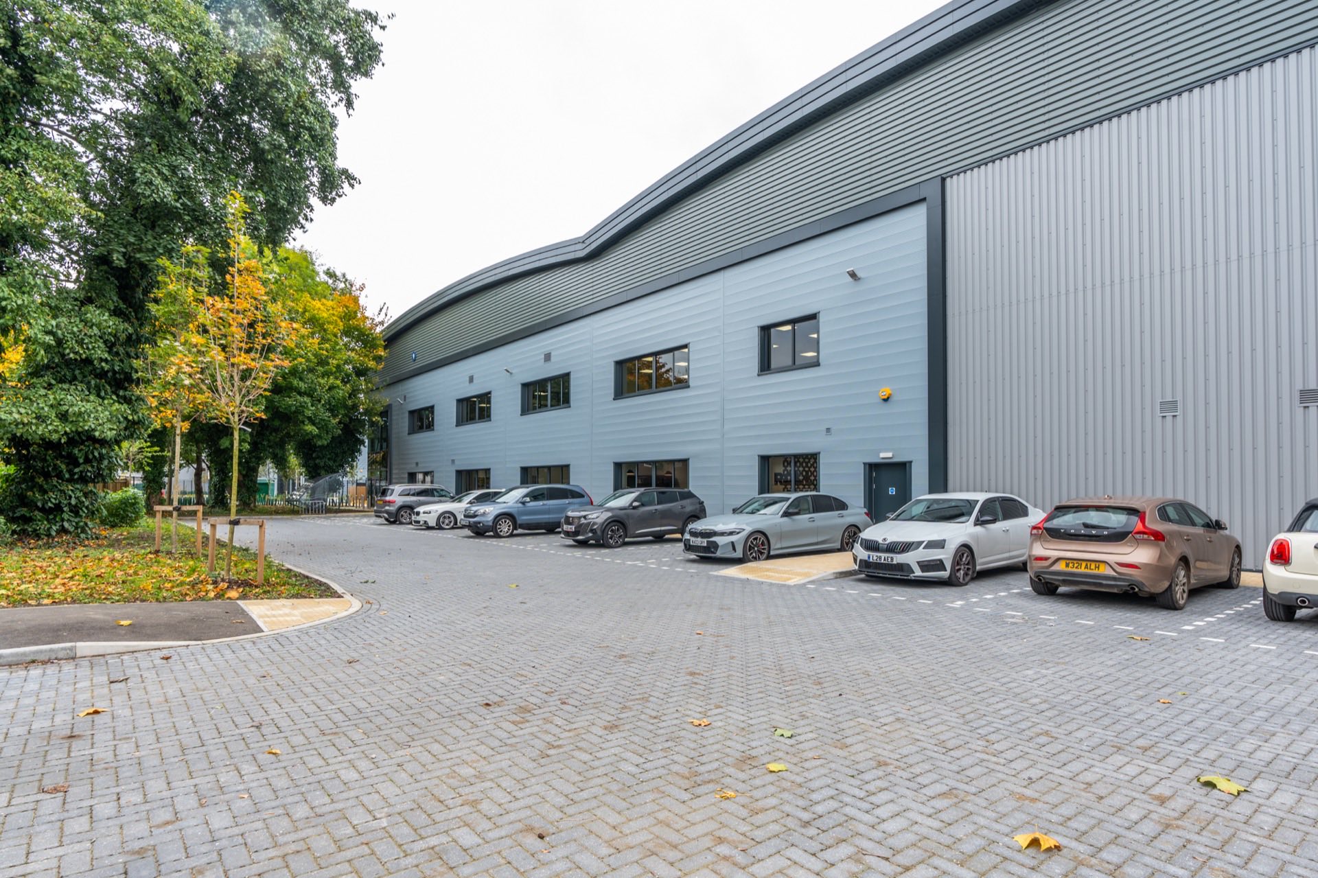 Exterior of the Garolla industrial unit, with grey cladding and a curved warehouse roofline